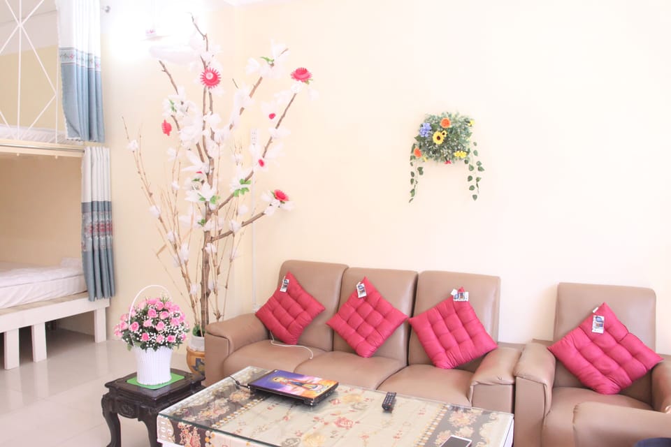 Sofa area and wooden table for guests to chat and watch TV