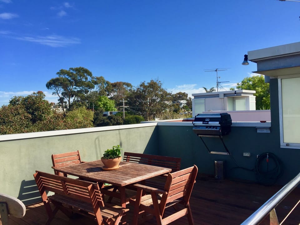 Barbecue and outdoor setting on roof deck
