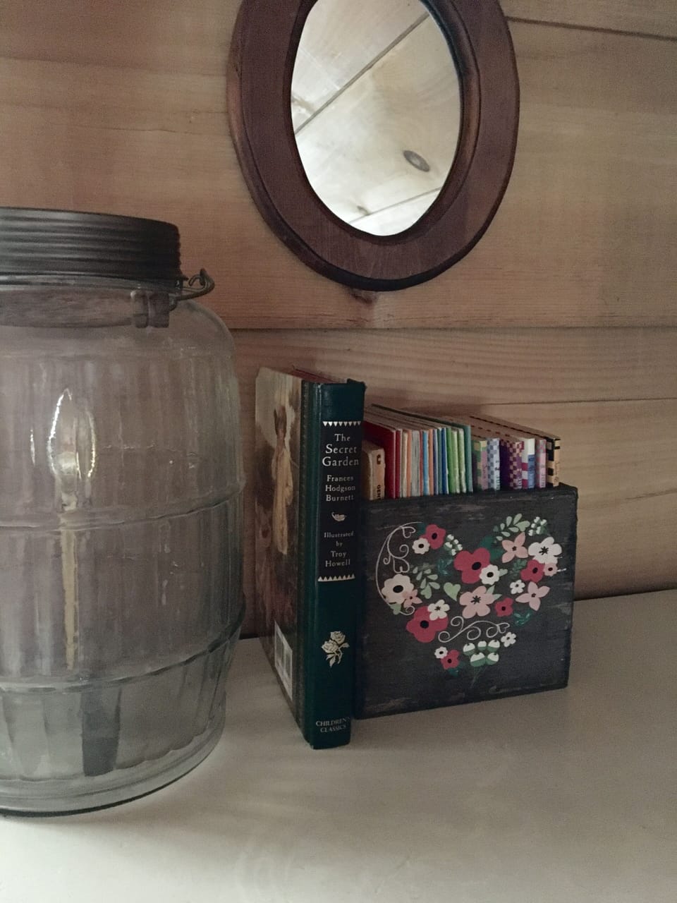 Children’s books, and a pickle jar lamp upstairs. Cozy loft area