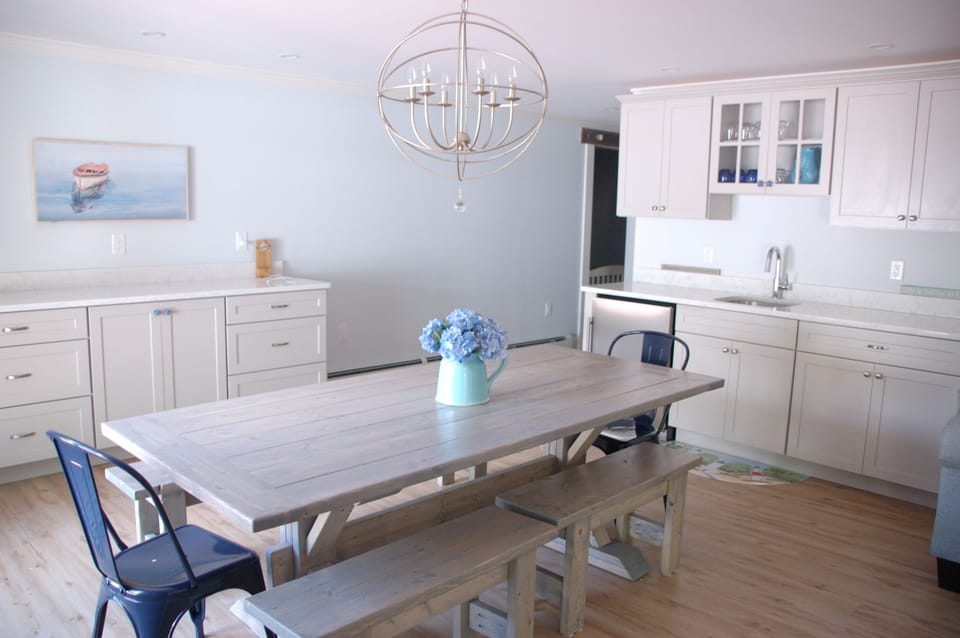 New finished basement with table, sink, entertainment areas 