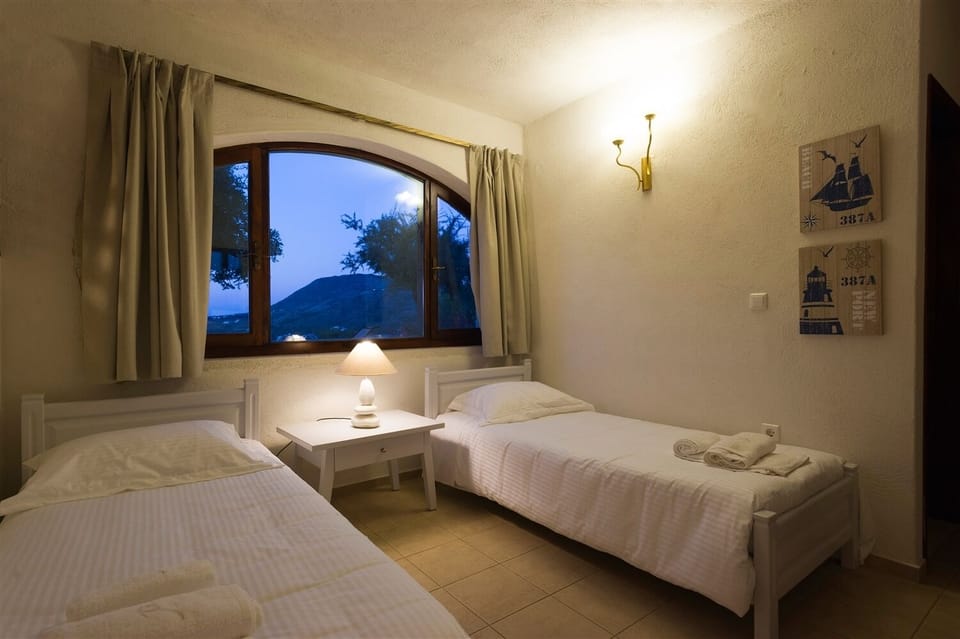 Villa Prinolithos ground floor poolside apartment twin bedroom area.