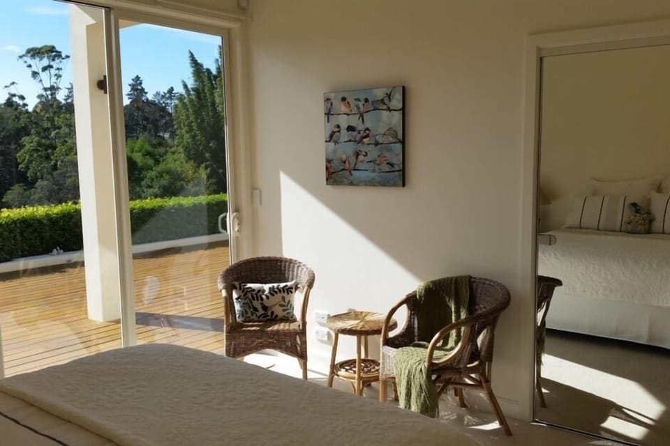 Seating area in bedroom with waterfall view