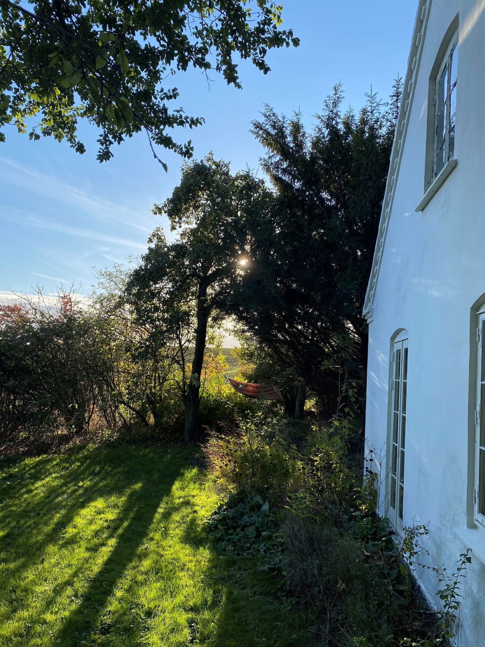 south facade and garden with hammock and fields