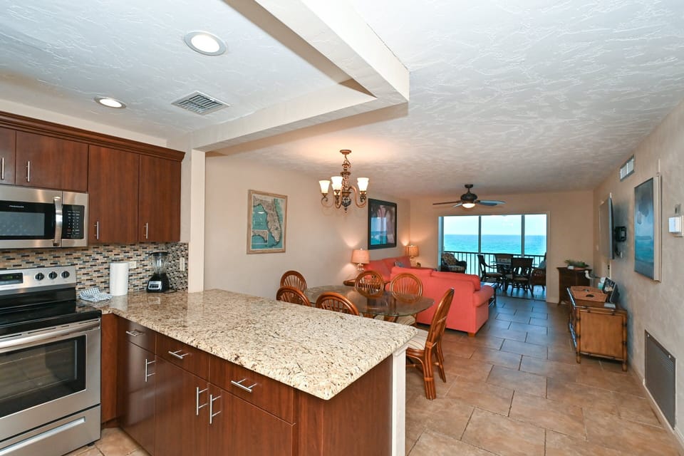 Modern, renovated, fully equipped kitchen with granite counters, glass tile backs splash...