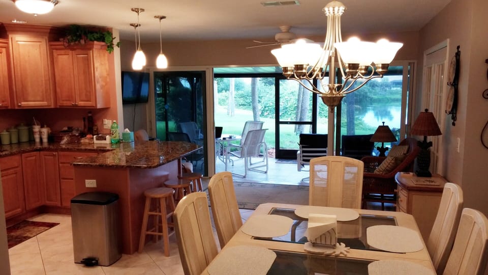 Dining area seats 8 with additional seating and table for 4 on the lanai.
