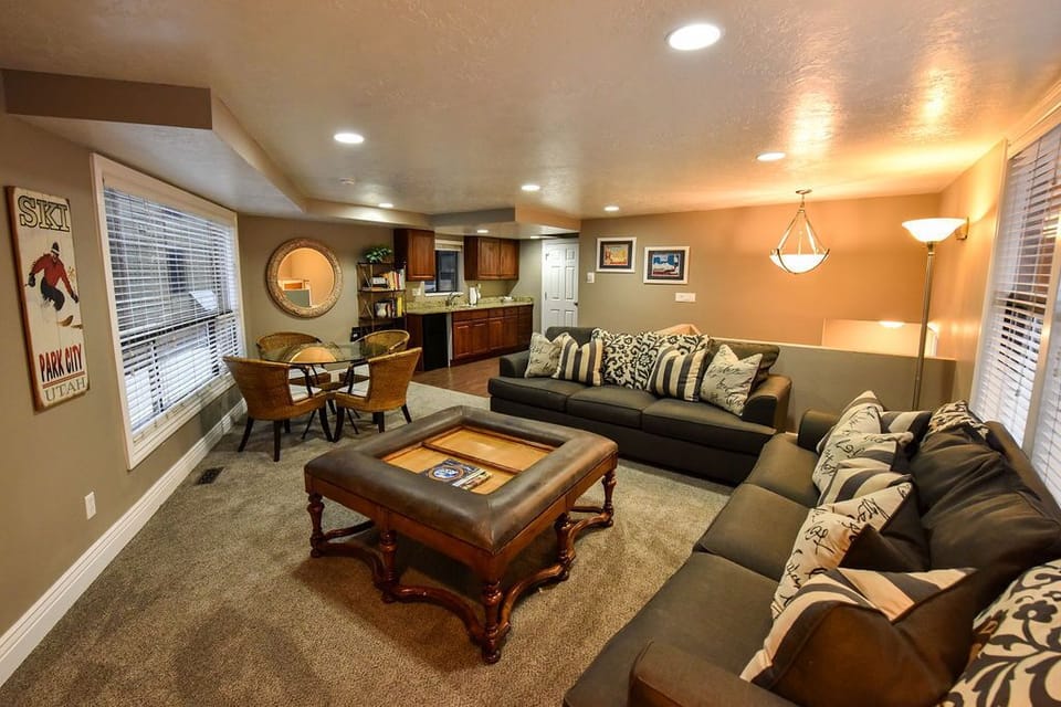 Living room with wood burning fireplace, game table and kitchenette 