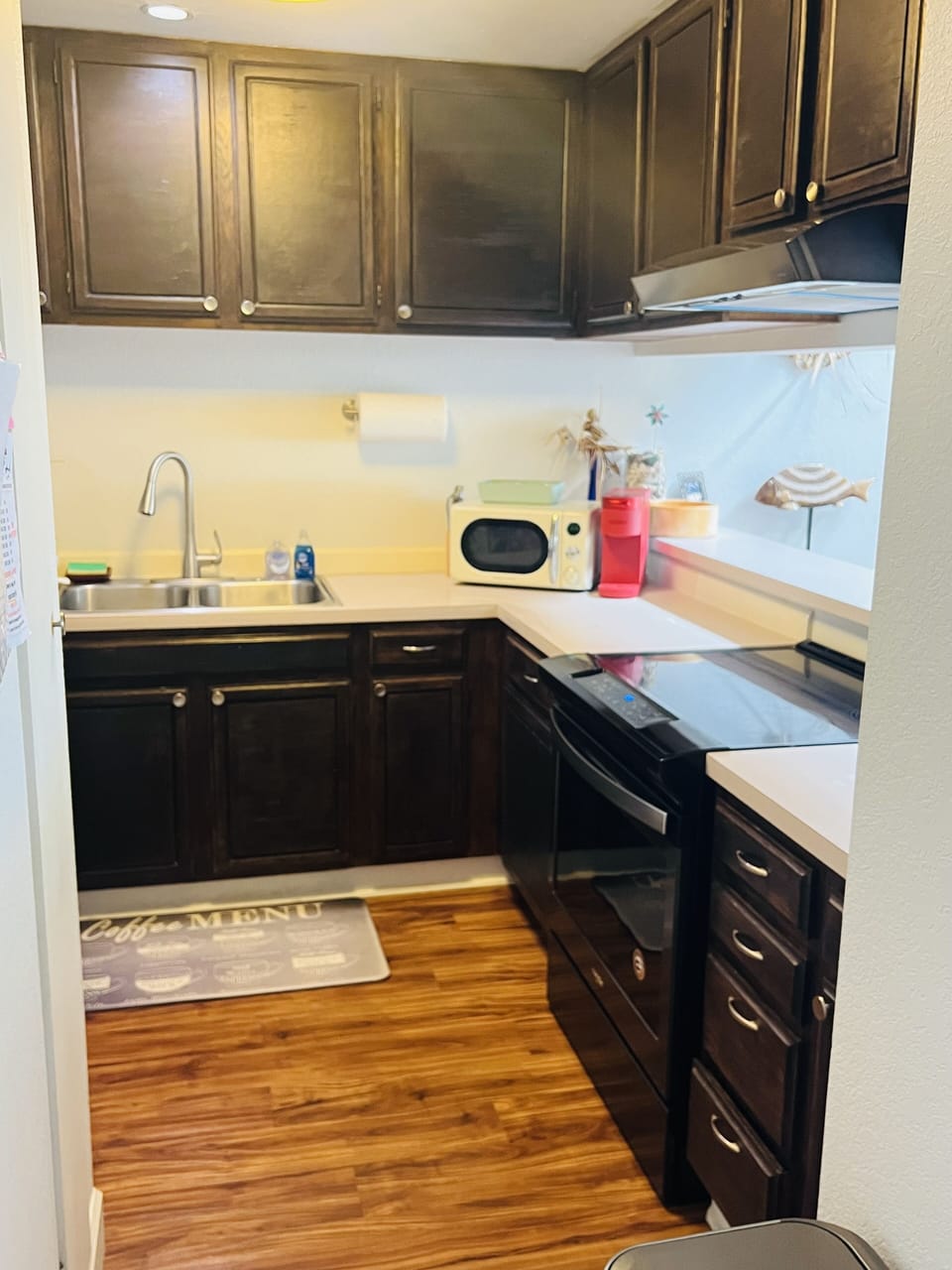 Full kitchen with pots, pans, silverware, kuerig, fridge, microwave, toaster