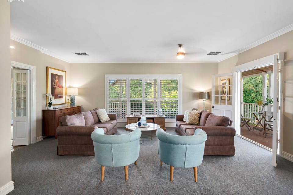Lounge with TV , billiard table, french doors onto deck with forest views