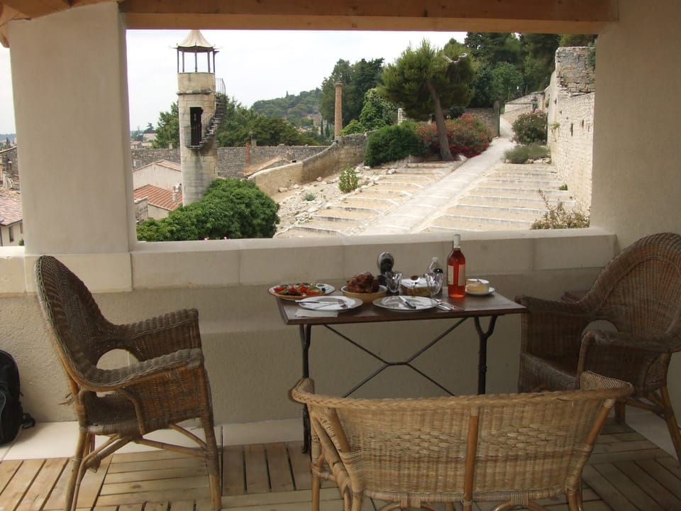 Covered dining area on the terrace looking onto the garden of the castle