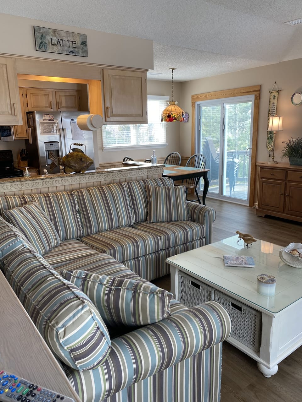 Comfortable sofa in great room. Walk out to upper level deck. 