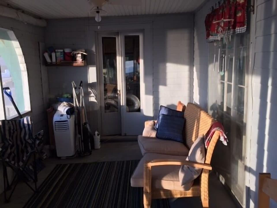 Screened in porch facing lake off veranda, kitchen and formal dining room.