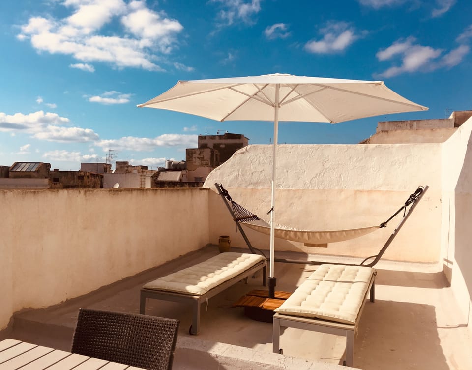 Private terrace with 2 lounge chairs, dining table for 6 and chairs, hammock 