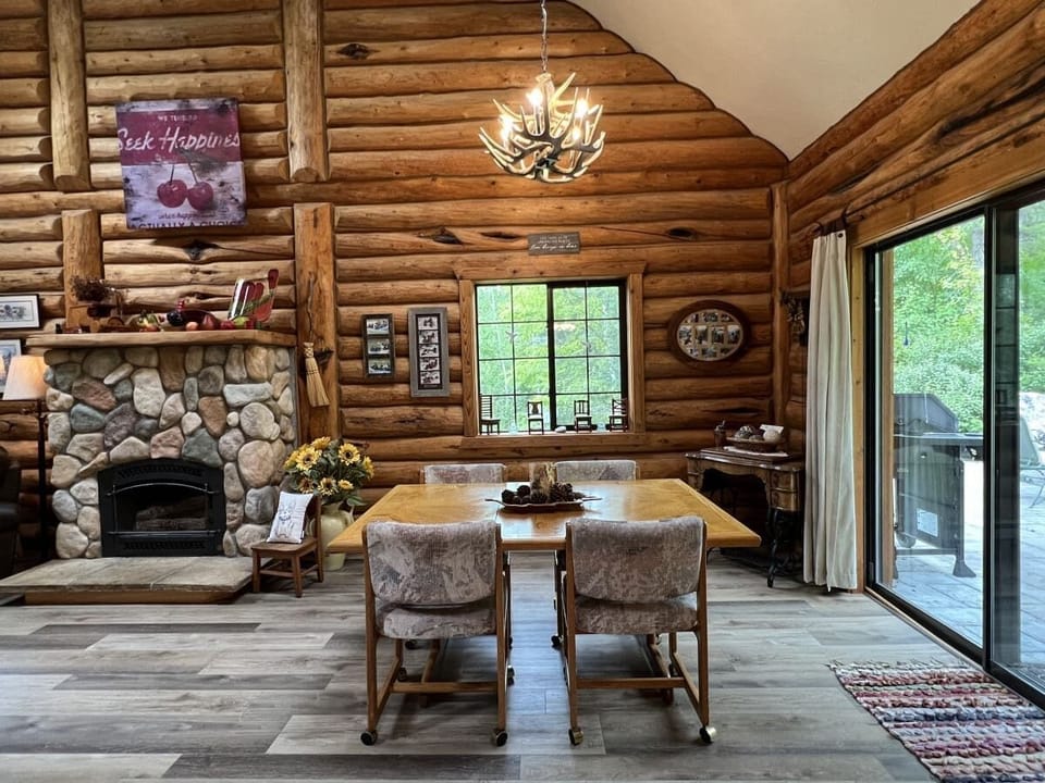 Dining room area with fireplace and back door to outdoor eating area