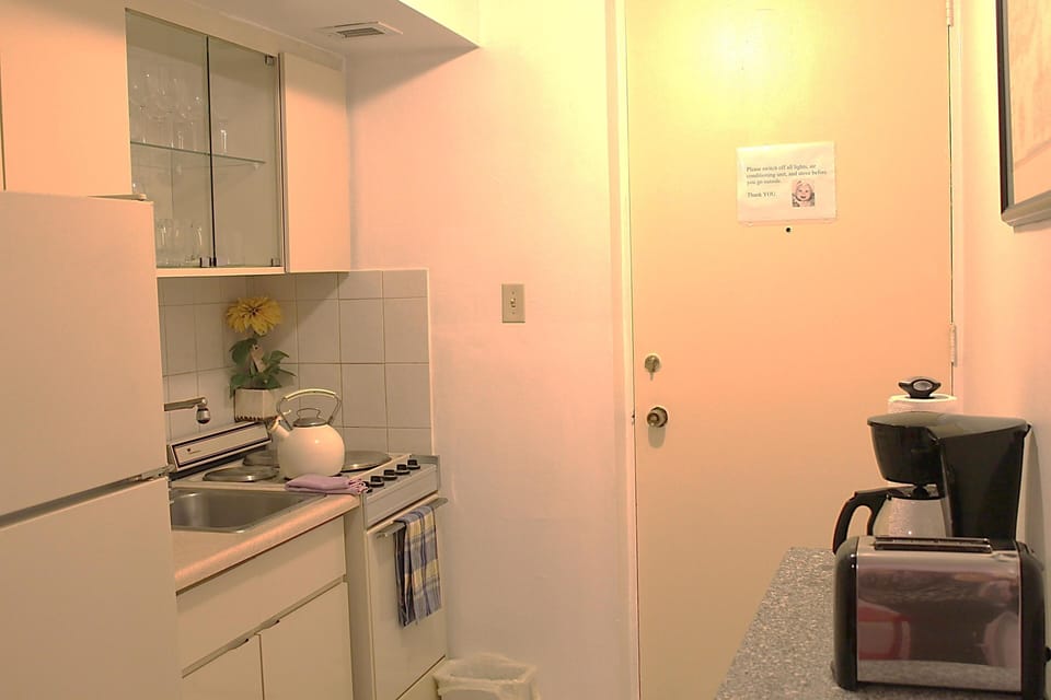 cooking area with full size refrigerator