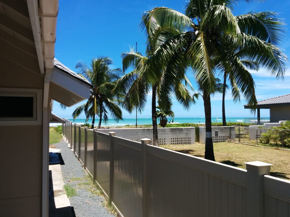 It's only a few steps around the main house on this beachfront lot to the sand!
