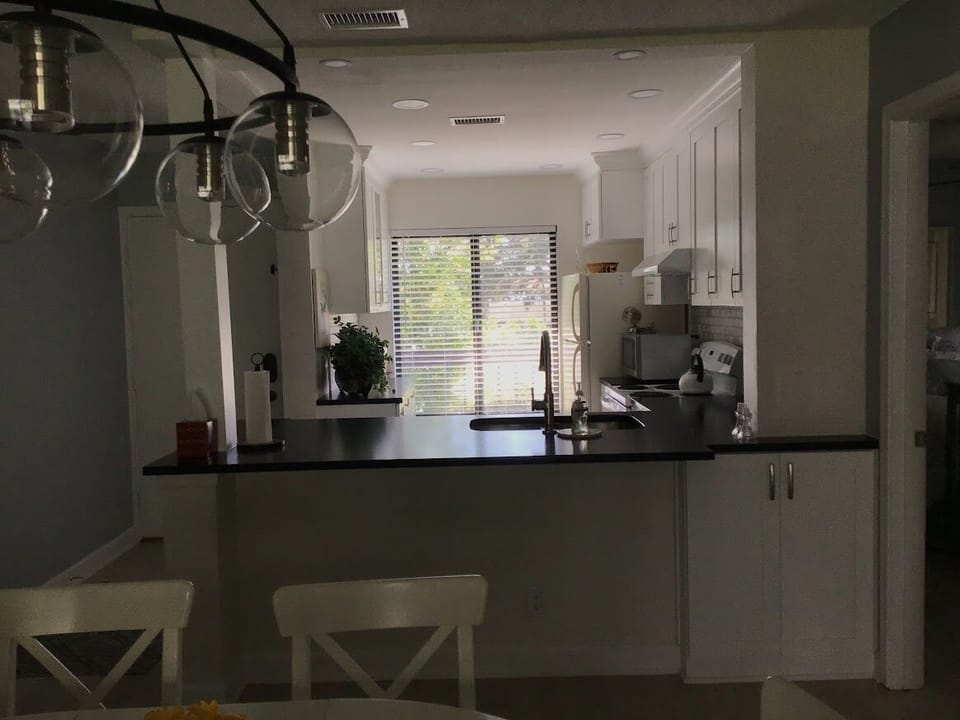 View of the Kitchen and Front door from the Living area