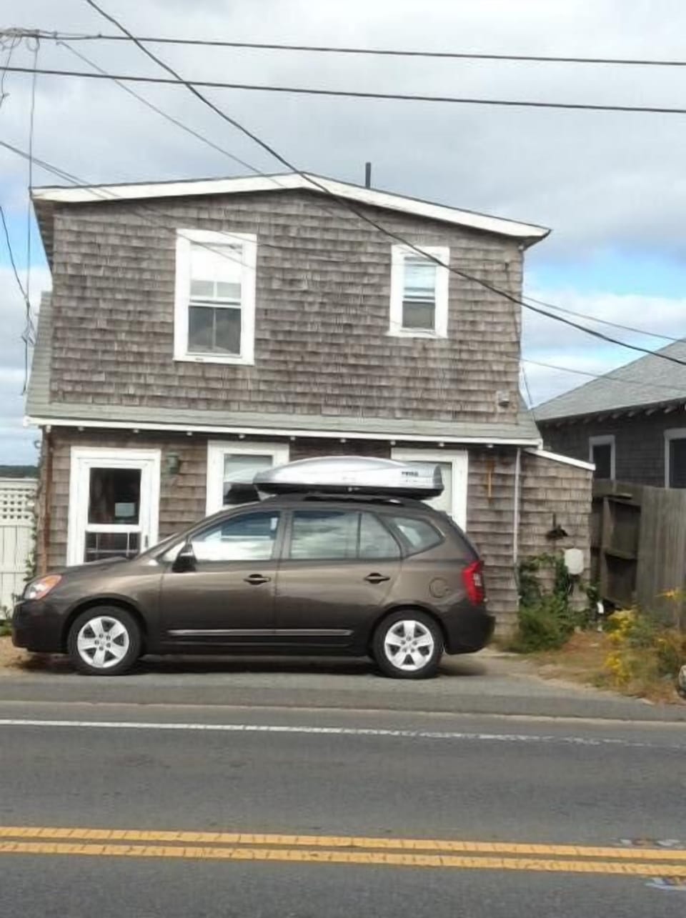 View from across road. Pond,lagoon is behind photographer. Ocean is behind house