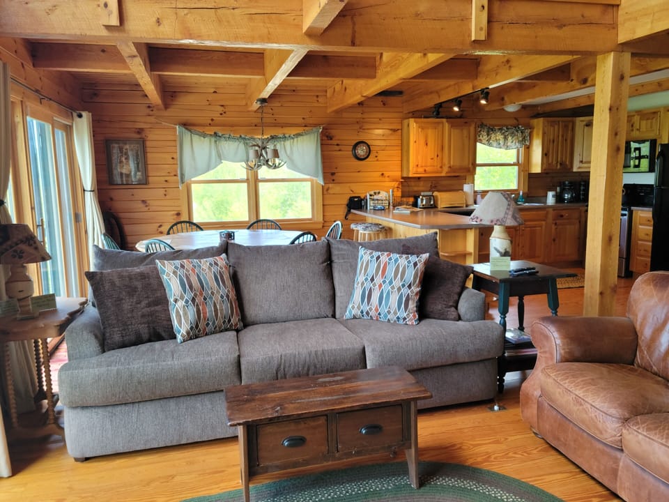 Open floor plan living room, dining area, kitchen. New sofa 2021