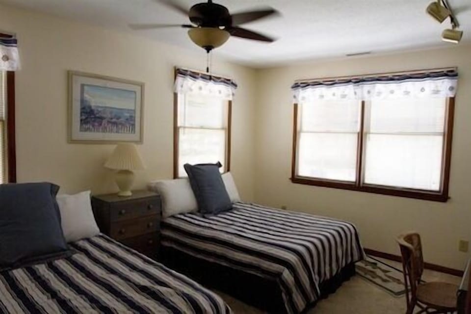 The second bedroom with two double beds will sleep four people comfortably and has a large sliding door closet.