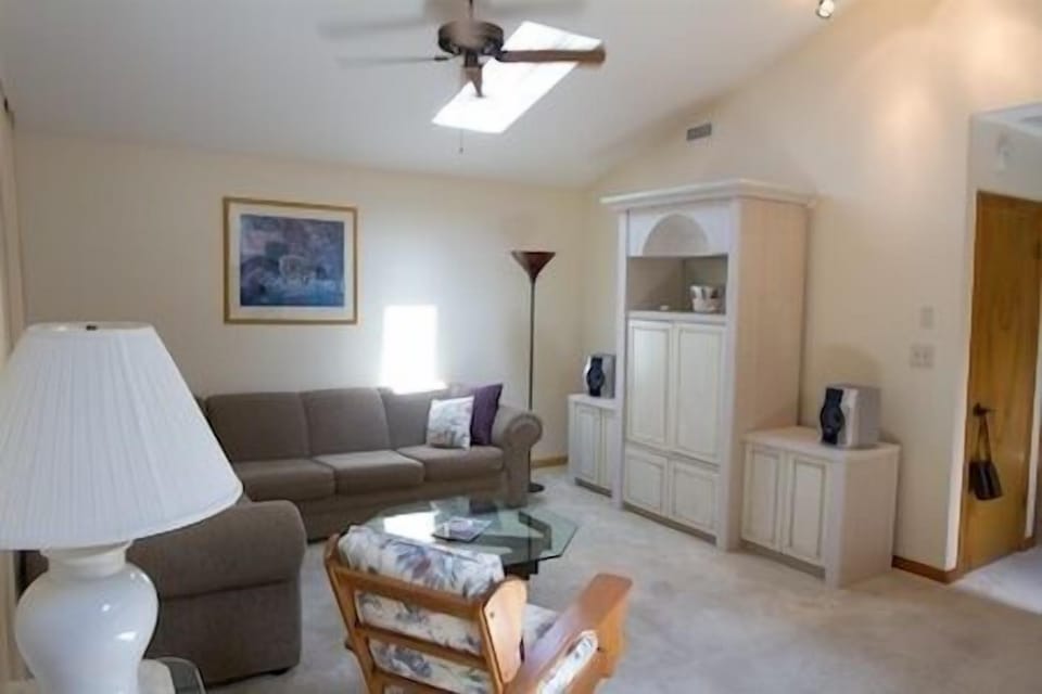 Living Room with vaulted ceiling and skylight gives off a soothing atmosphere and also provided, is a pullout queen size sofa.