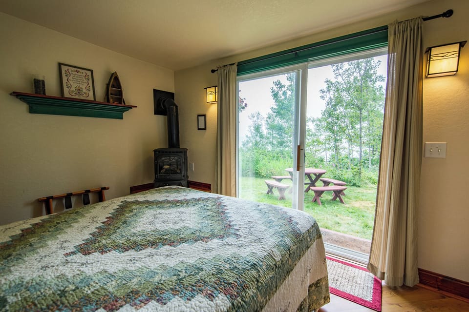 Lake Facing Bedroom
How can it get better than this. Imagine laying on the plush queen bed reading a good book within the glow of the gas stove. As you look out the patio door you have Lake Superior laid out in front of you in Cottage #2.