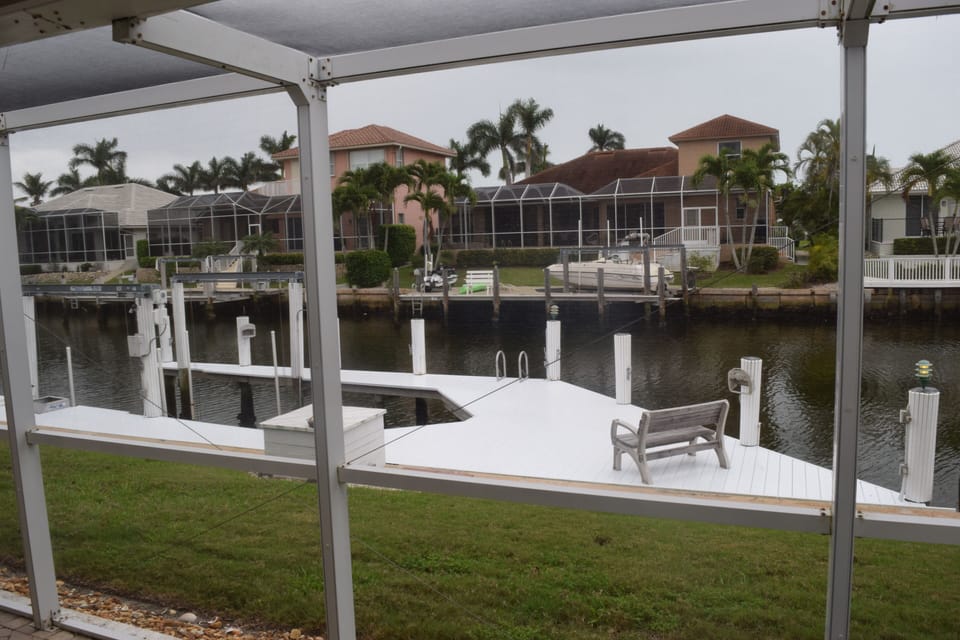 Large updated dock with boat lift and seating.