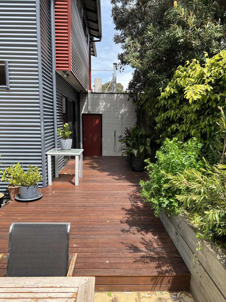 Side decking.  Door into garage.  Outdoor shower.