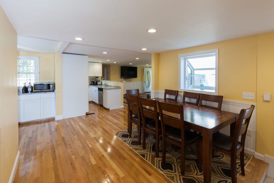 Dinning room w/seating for 10. Shows open floor plan into kitchen & living room