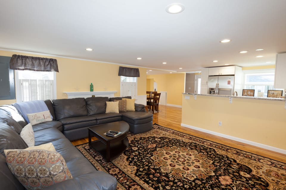 This room has a 65" TV and the most comfortable couch has seating for 10. 
