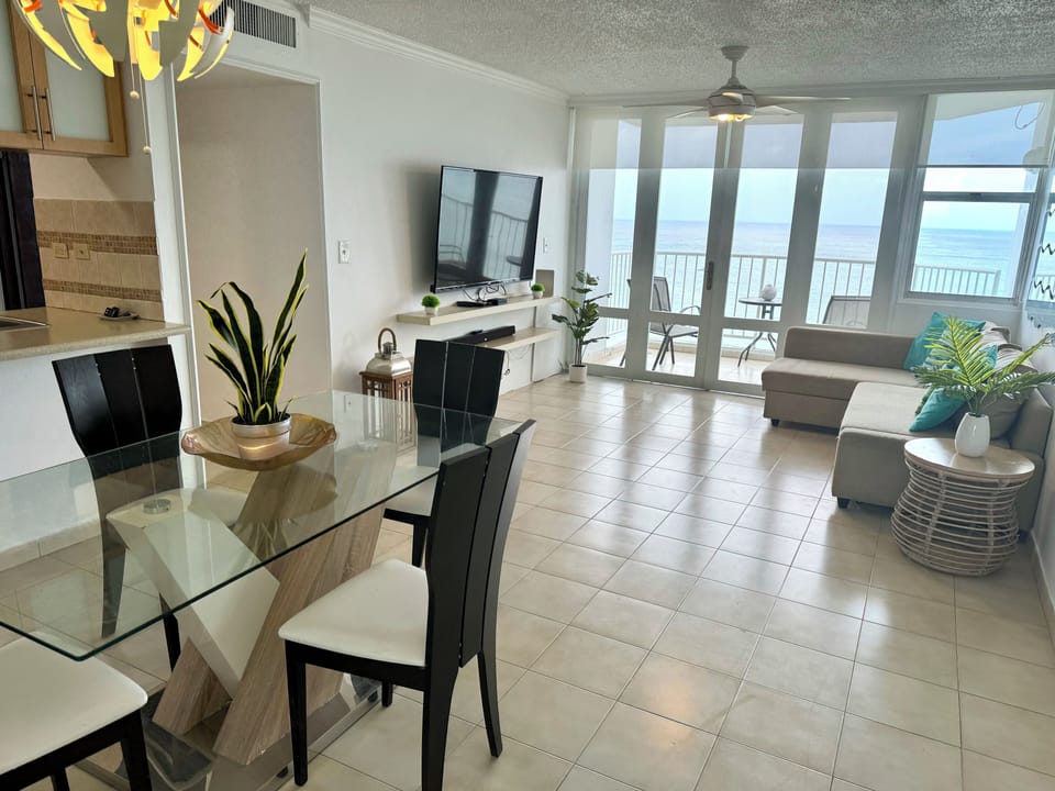 Dinning table, sofabed, tv and balcony with ocean view