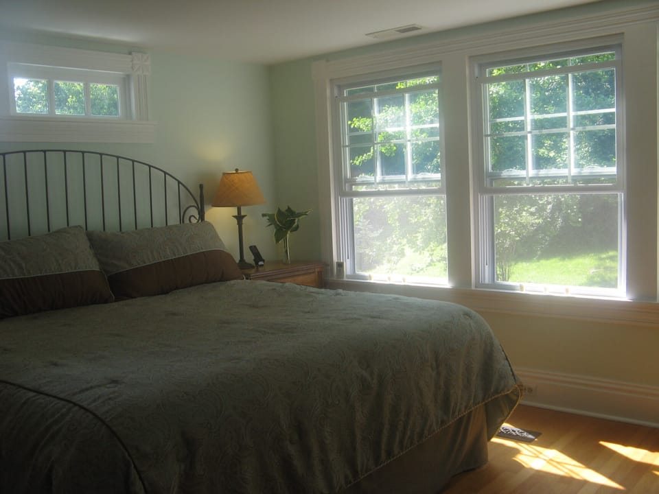 The master with views of the garden and woods offers great birding from bed!