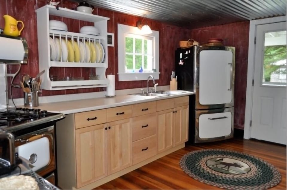 reproduction frig... to match stove .... love the window overlooking backyard.