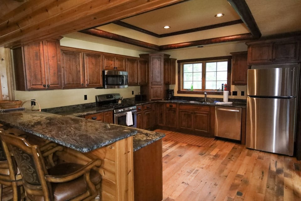 Large kitchen which opens directly into large screen porch. Bar top seating.