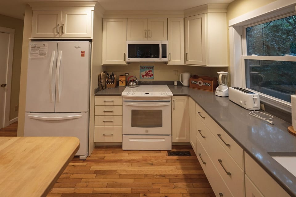 All white cabinets, appliances, huge fridge with freezer
