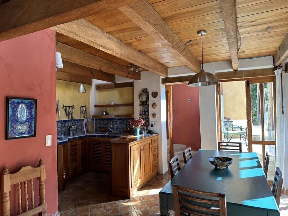 Kitchen - dining table opens onto and encompasses a great view of the garden. 