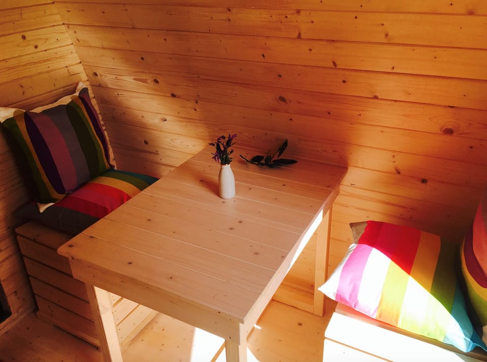 Inside pod, queen bed and sitting area 