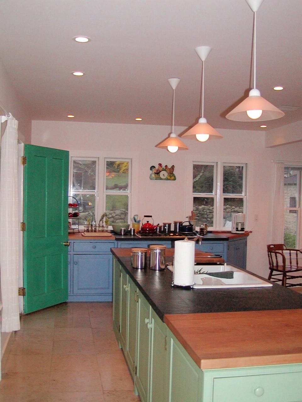 Kitchen with door to side porch & view th back yard