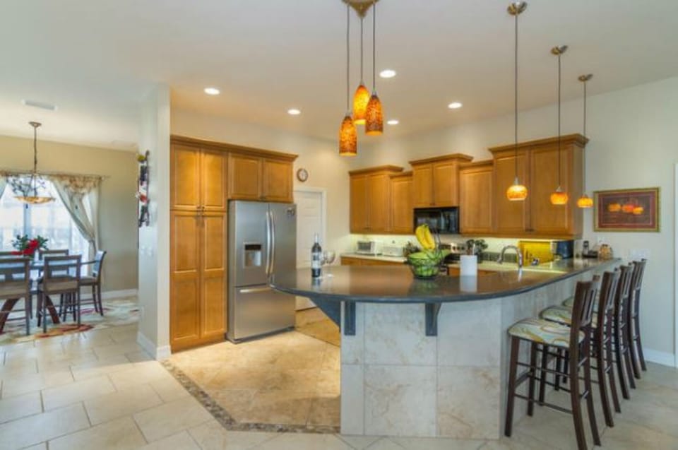 Kitchen social space bar stools to chat with the cook for food prep ,fridge 