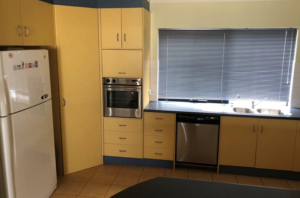 Kitchen with large fridge, wall oven, microwave, stove and dishwasher