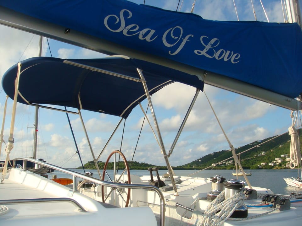 BVI CATAMARAN CHARTERS, DAY SAILING AND SNORKRLING, enjoy the best of the BVI. Docked boat in Caribbean