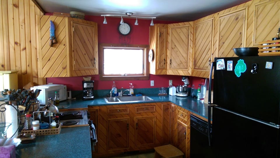 Fully-stocked kitchen. Note tip of piano on the left. Abuts the dining rm space