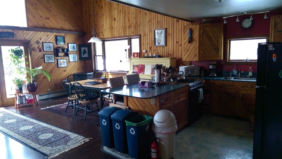 Kitchen and dining room from guest bathroom door.