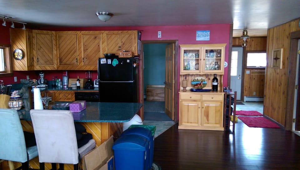 Kitchen, guest room door, and entry way from main living area.