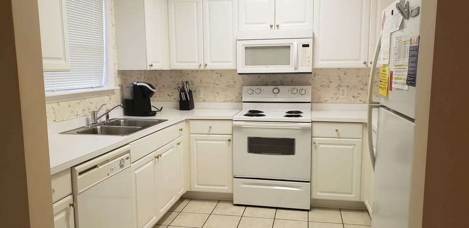 Full Kitchen with refrigerator, stove, microwave, and dishwasher