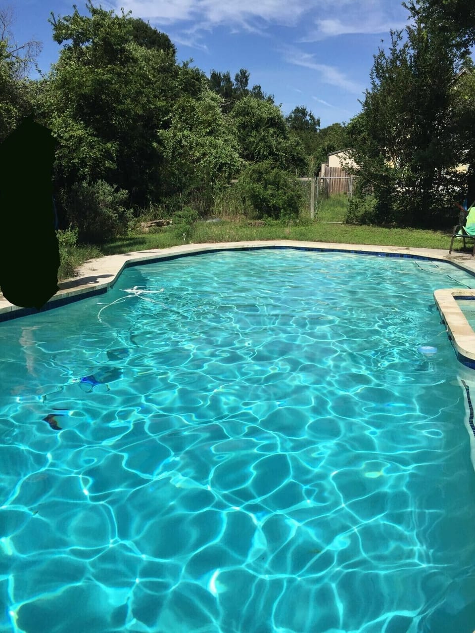 Pool - hot tub on right.  Facing cottage