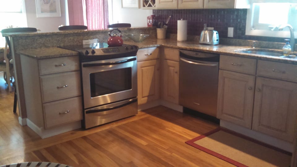 Granite and stainless in bright cheery kitchen
