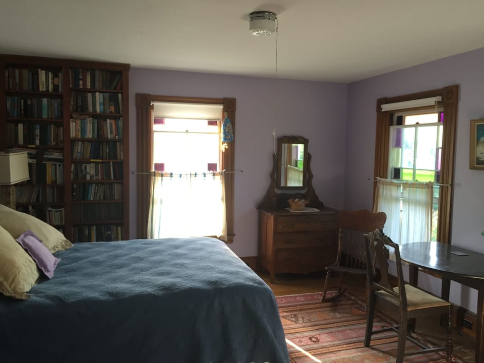 Upstairs, a queen bedroom with lots of books and its own stained glass ...