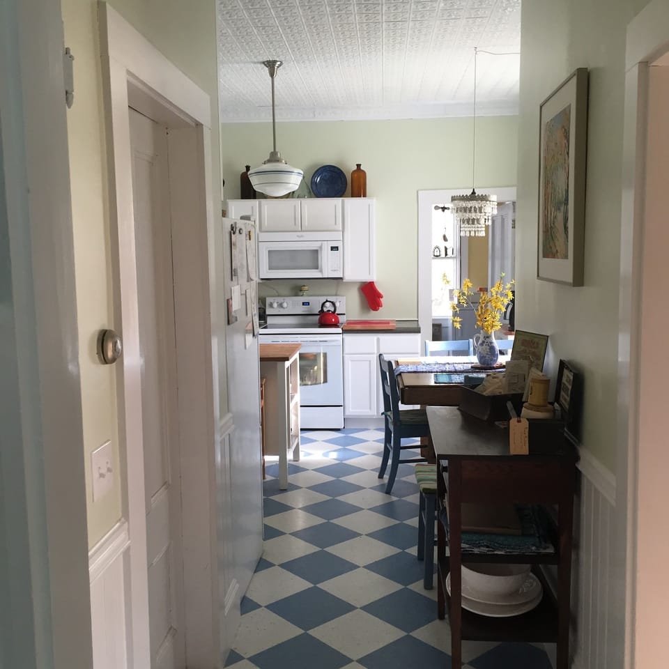 Off the dining room, the entry to the eat-in country kitchen, with local art.
