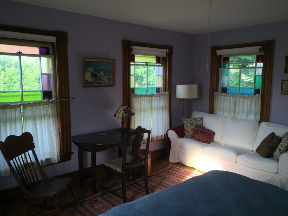 A master bedroom, with reading nook. Great morning and afternoon light. 