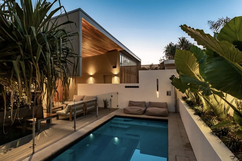 Private swimming pool set among lush landscaped gardens.